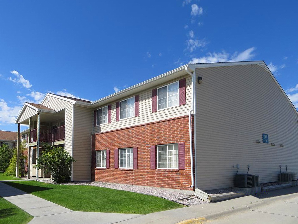 Cottonwood apartment building beneath a bright blue Nebraska sky